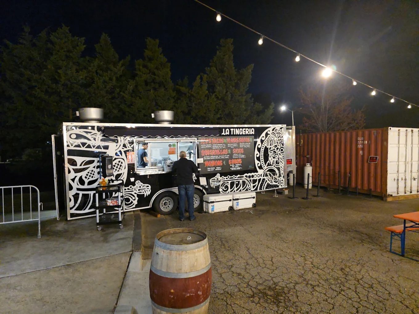 La Tingeria branded food truck trailer serving customers at night with string lights, Alexandria, VA