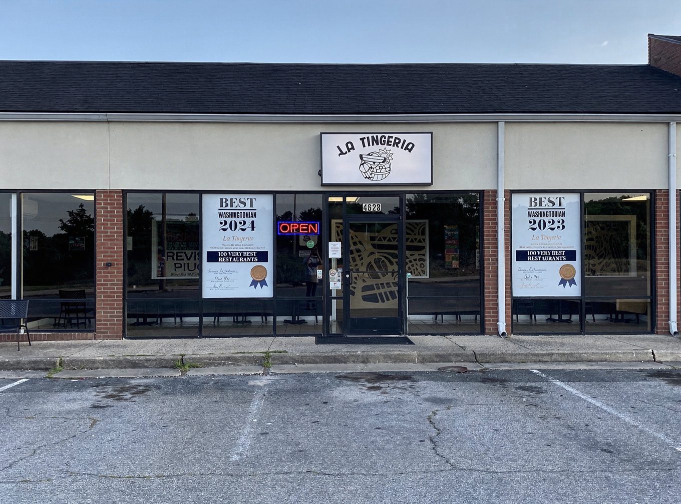 La Tingeria Spotsylvania storefront with illuminated sign, OPEN neon light, and Washingtonian "100 Very Best Restaurants" award posters in the windows